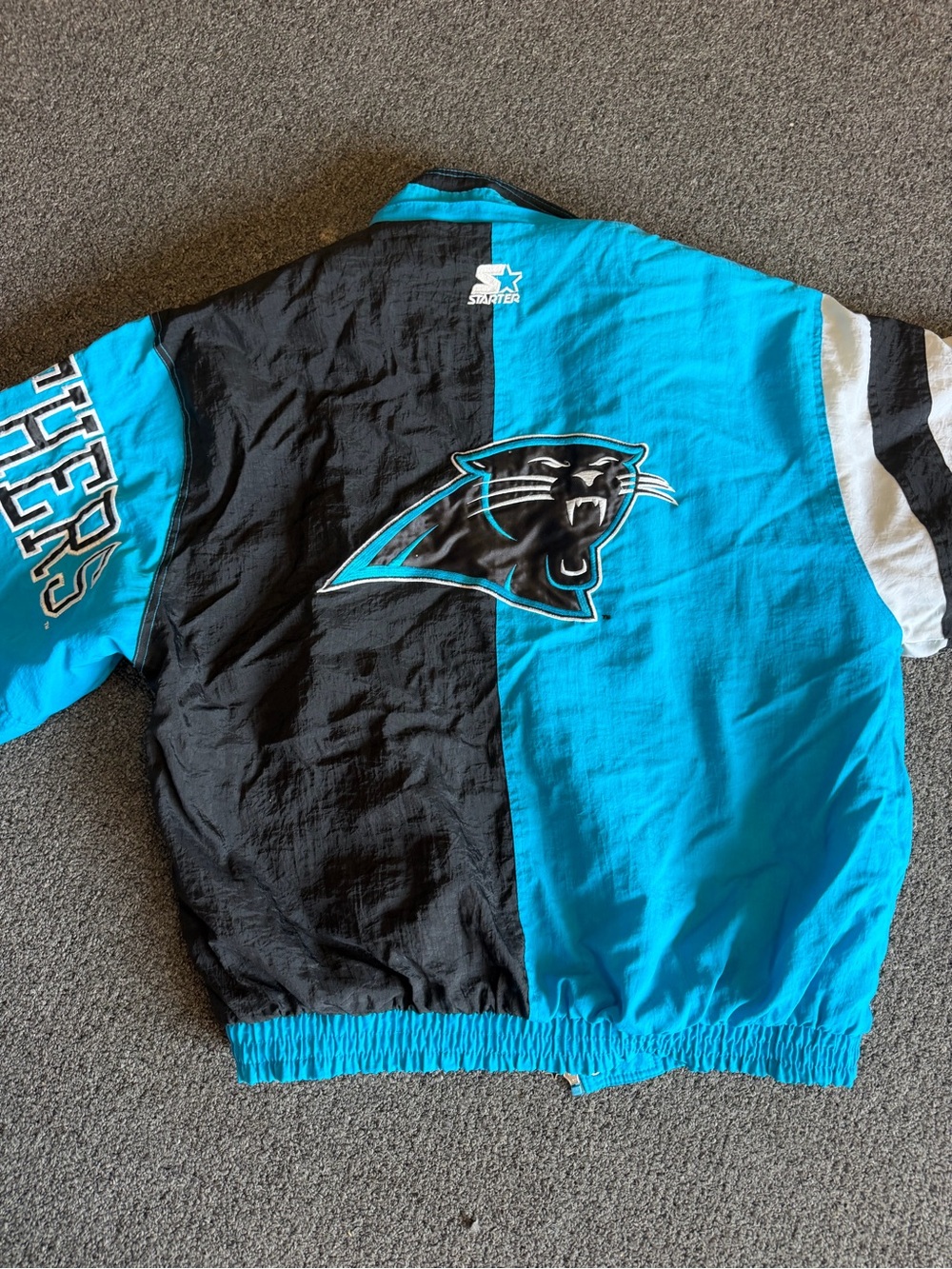 STARTER Carolina Panthers Half-Black Half-Teal Puff Jacket